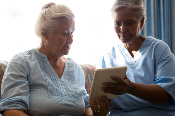 istock Doctor showing digital table to senior woman 830373342
