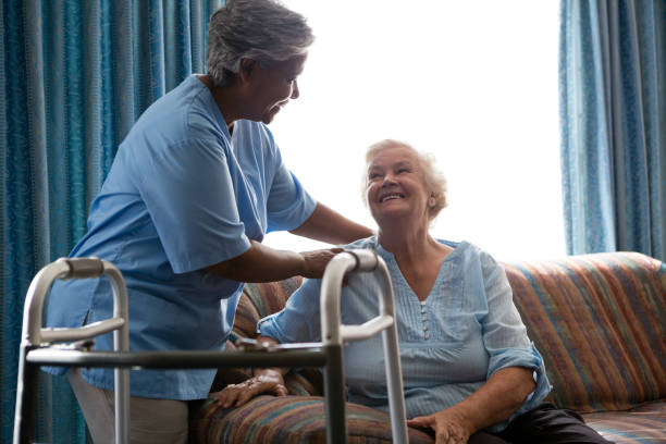 istock Nurse helping senior woman in standing 830374980