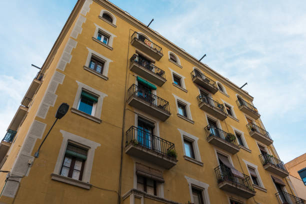 istock big yellow apartment building with small steel balconies 830384634