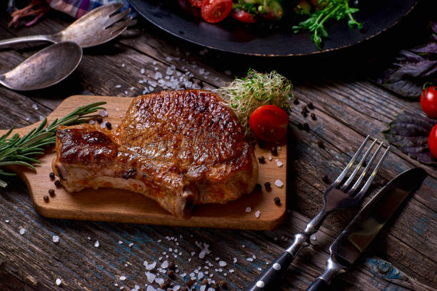 istock Grilled meat and vegetables on rustic wooden table 830400398
