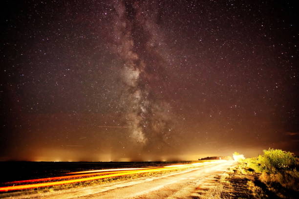 istock Countryside road towards the milky way. 830403700