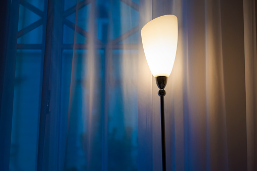 Interior of a living room, evening lamp in a room