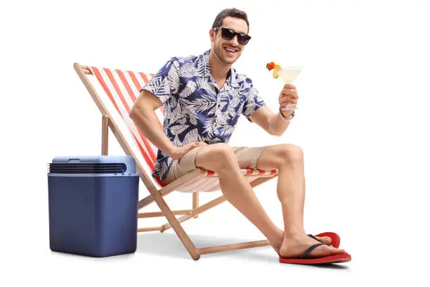 Photo of Tourist sitting in deck chair and looking at the camera