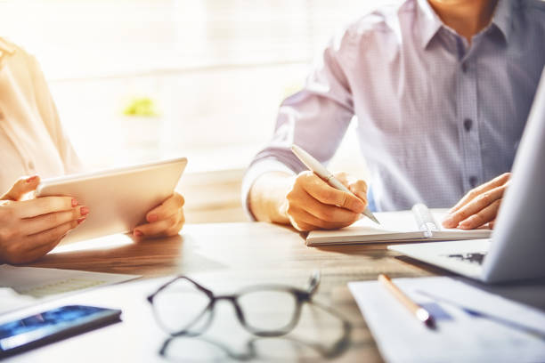istock man and woman working in the office 830412908