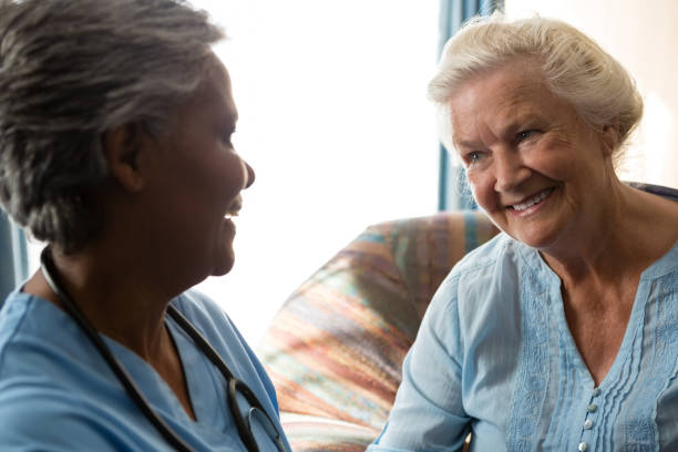 istock Nurse talking to senior patient in nursing home 830420044