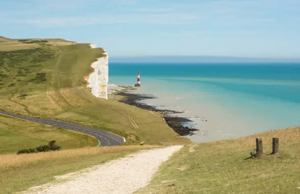 The lighthouse and white chalk cliffs at Beachy Head near Eastbourne, East Sussex, England
