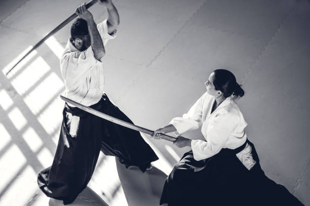 istock Two Aikido Fighters With Bokken Swords 830427270