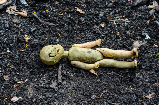 antiga boneca quebrada na pilha das cinzas - doll evil child baby - fotografias e filmes do acervo