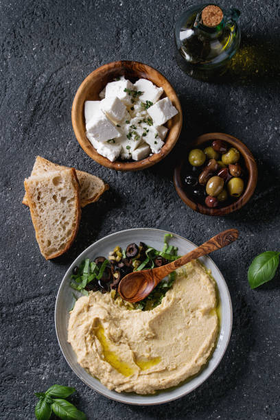 istock Hummus with olives and herbs 830429688