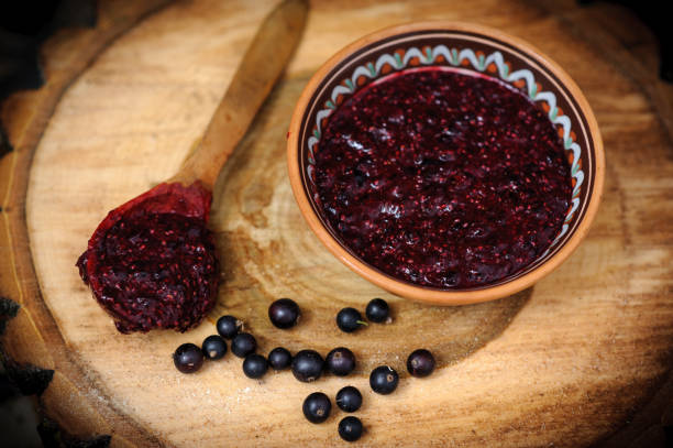 Fresh toast with homemade butter and blackcurrant jam on wooden