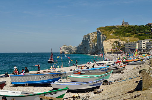 Etretat, France - June 02, 2011: Unidentified people and boats on beach of the  sea ressort on English channel coast in Normandy