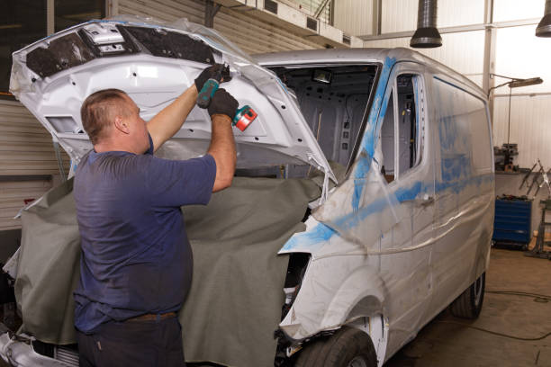 istock Mechanic repairing car with open hood 830452018