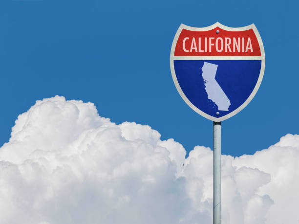 istock Highway sign for Interstate road in California with map in front of clouds 830457578