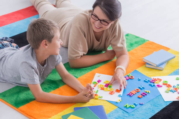 Young woman and kid solving puzzle on floor