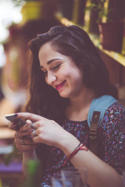 istock Cheerful Girl Texting Messages 830460066