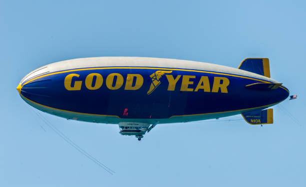 Famous Goodyear blimp flies over California beach. stock photo