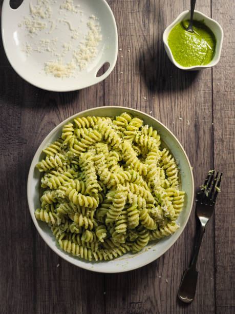 healthy pasta with green pesto sauce - pasta directly above fusilli food imagens e fotografias de stock