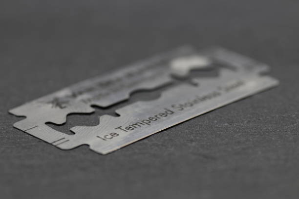 razor blade Razor blade in close-up razor blade stock pictures, royalty-free photos & images