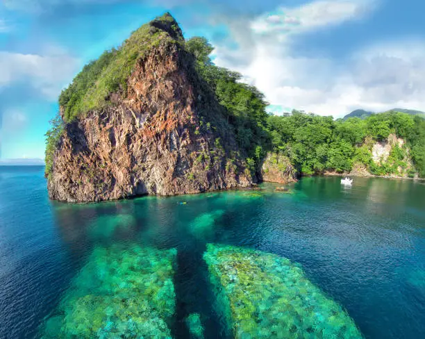 Some years ago part of rocky hill broke off and fell in Caribbean sea,splitting in two. It now is a fine snorkeling and free diving destination in Toucari Bay area, Dominica, Eastern Caribbean (Windward Islands). aerial photo taken with drone.