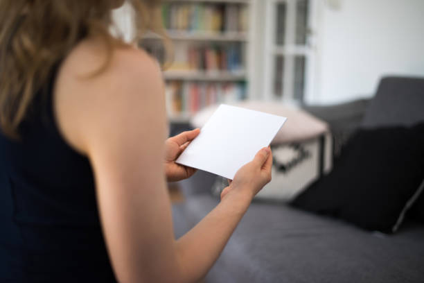 istock Woman holding a blank brochure with copy space in her hands 830531494