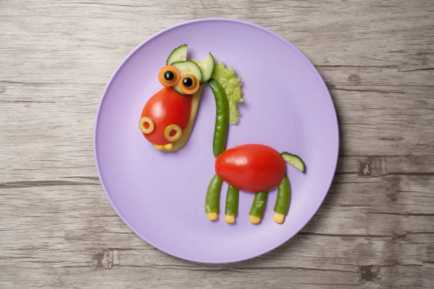 istock Funny vegetable horse made on plate and desk 830540158
