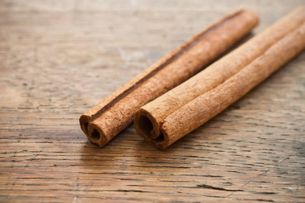 istock Dried  cinnamon on wooden  background 830547336