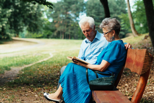 istock Seniors reading book together 830547730