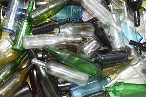 Glass bottles inside a glass recycling container