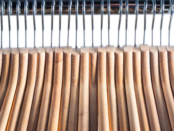 istock Wooden hanger on metal rail over white isolated background 830548206