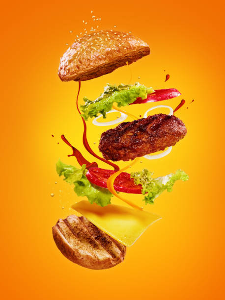 istock The hamburger with flying ingredients on orange background 830561926