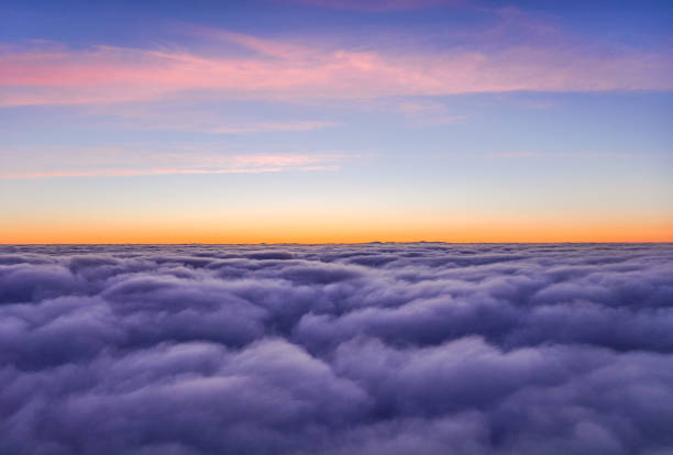 istock Stunning view above the clouds shortly after sunset seen from an airplane shortly before landing in Iceland. Tranquil scene with beautiful colors. 830568228
