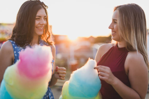 istock Female friends at amusement park 830581152