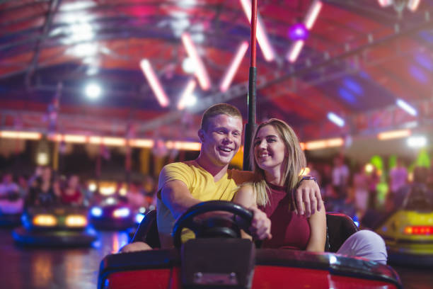 istock Young couple in bumper car at amusement park 830581196