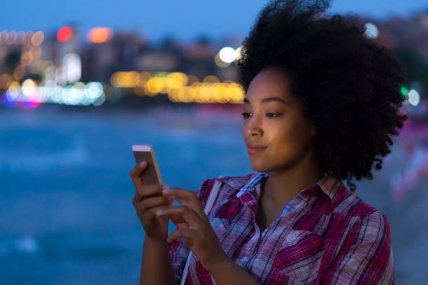 istock Woman taking selfie on beach at night 830595174