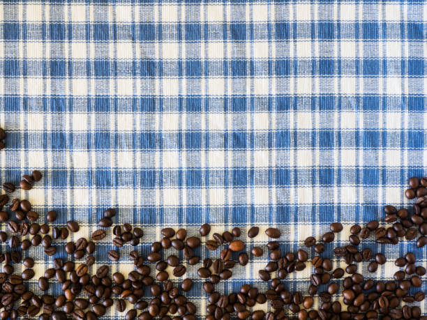 Coffee beans, ice cubes and white and blue paper drinking straws pattern on pastel blue background. Summer drink minimal concept. Flat lay composition.