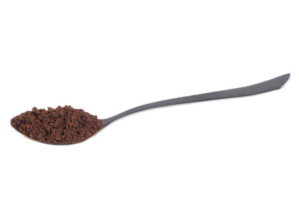istock Steel spoon with grounded coffee over white isolated background 830622000