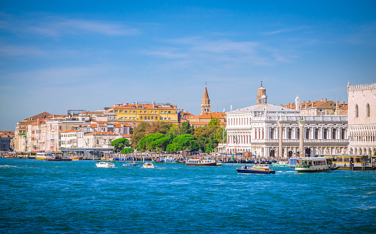 View of Ponta della Dogana and Santa Maria della Salute church dome from the Giudecca Canal at Venice, Italy. The building Dogana da Mar in Dorsoduro was built in the 15th century for customs and docking porposes and is now an art museum. It is right in the point where Grand Canal and Giudecca Canal meet and in front of the main island of Venice and it can be seen from the main island through the Grand Canal.