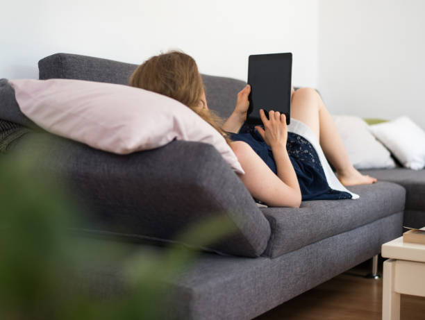 istock Woman looking at a digital tablet computer with blank screen and copy space 830647254