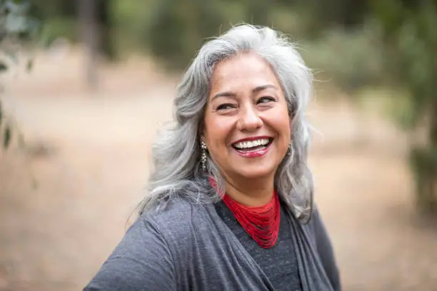 A beautiful white-haired Mexican woman in nature