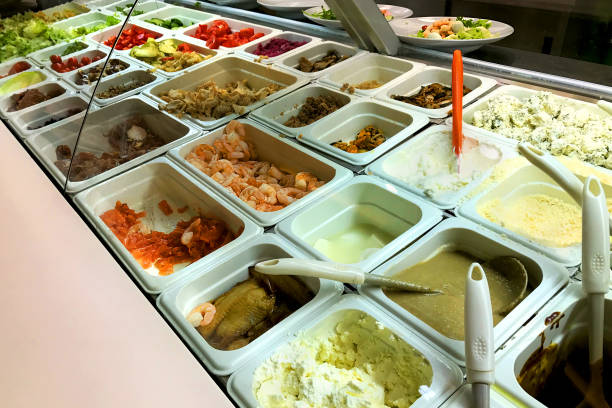 istock Different salads choice in containers fast food in buffet. Different ingredients - shrimp, tomato, lettuce, fish, fried and grilled vegetables and other various foods. 830668786