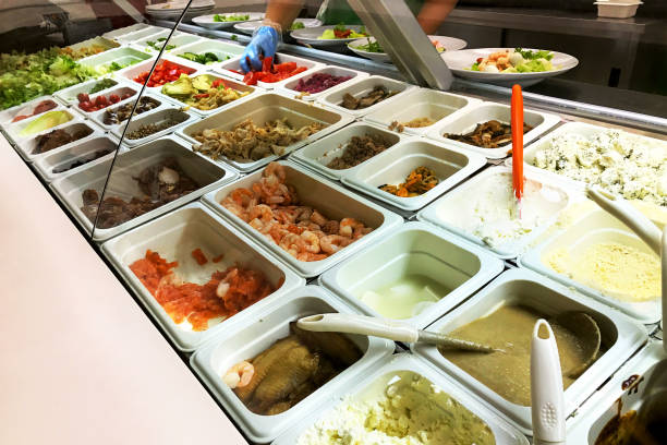 istock Different salads choice in containers fast food in buffet. Different ingredients - shrimp, tomato, lettuce, fish, fried and grilled vegetables and other various foods. 830669084