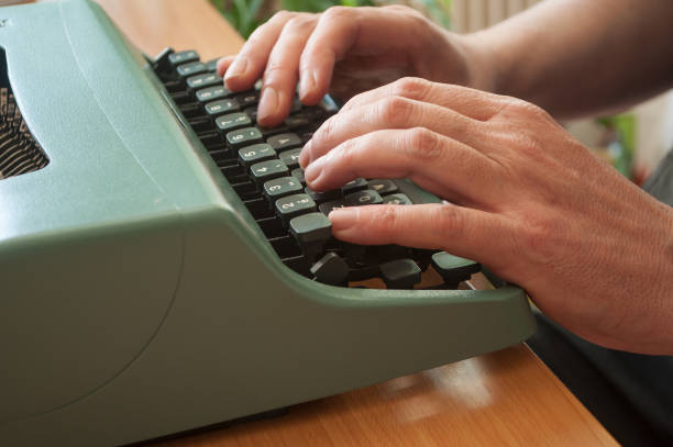 istock hand of man with typewriter 830670988