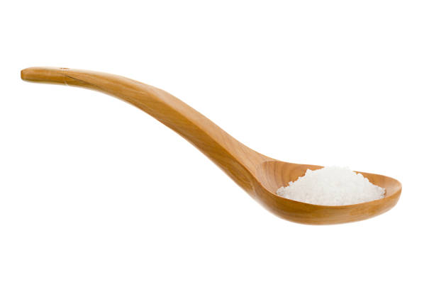 Wooden shovel of sea salt isolated on white background.