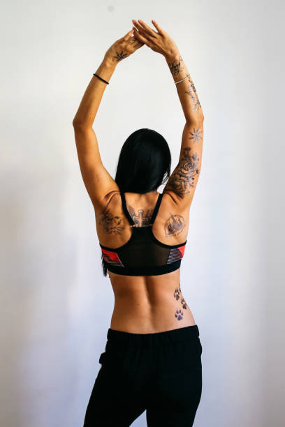 istock Young woman with tattoos relaxing before the training 830687552