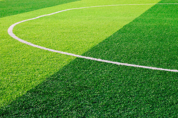 istock The white Line marking on the artificial green grass soccer field 830724652