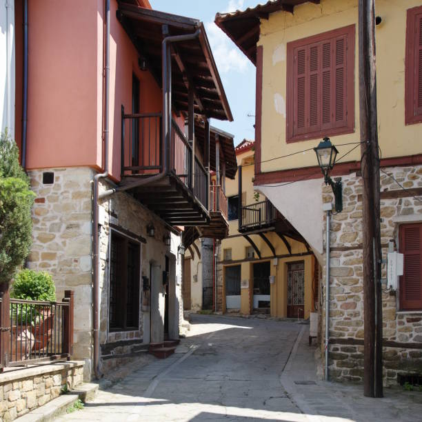 Small town near the Chalkidiki peninsula in northen Greece. Region of Macedonia. Street in the city center. Along the road are houses with typical architecture of the region.
