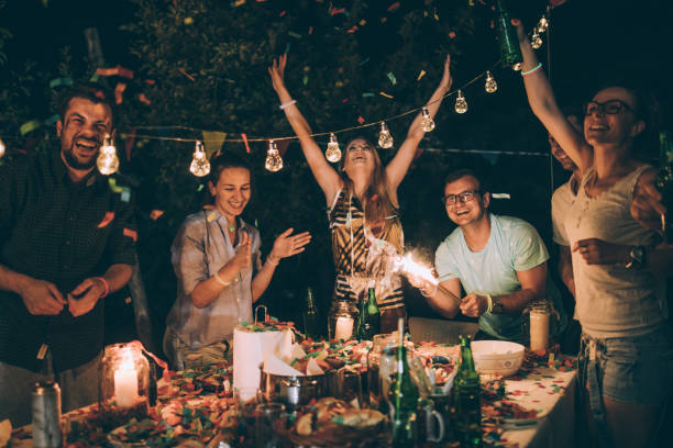 istock Group of young friends having fun at backyard party 830738360