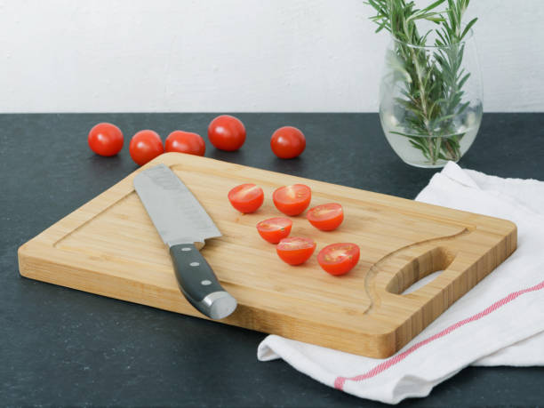 istock Sliced cherry tomatoes on a cutting board. Cooking food. 830750812