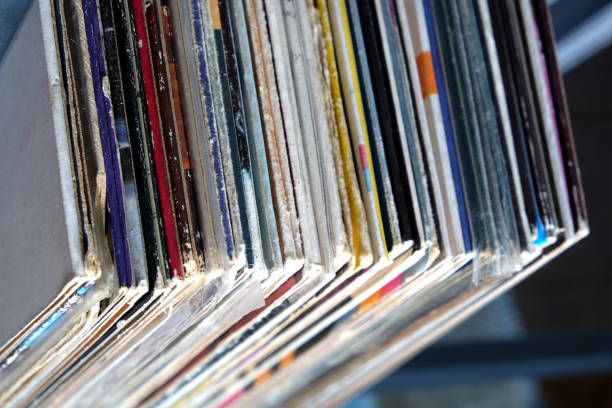 istock Stack of many vinyl records in old color covers on a shelf top view 830753870