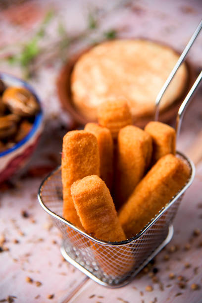 istock fish sticks in a metal basket and spanish omelet 830770970